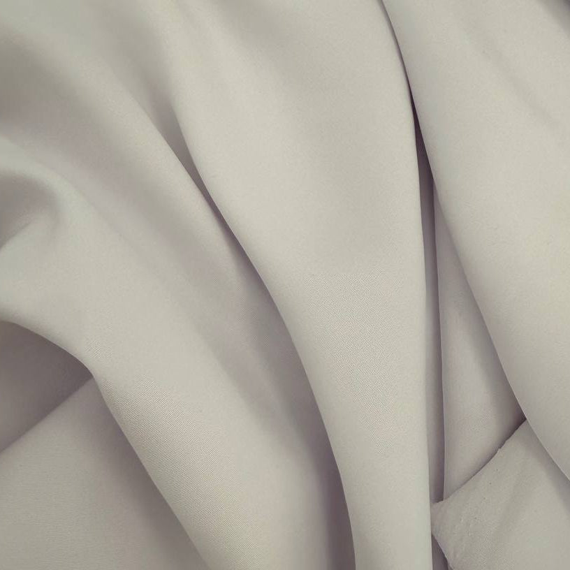 White dress crepe fabric with soft drape and matte finish 