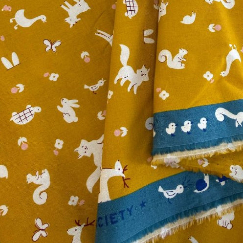 Mustard yellow Woodland Park cotton fabric with white woodland animals and floral print by Ruby Star Society