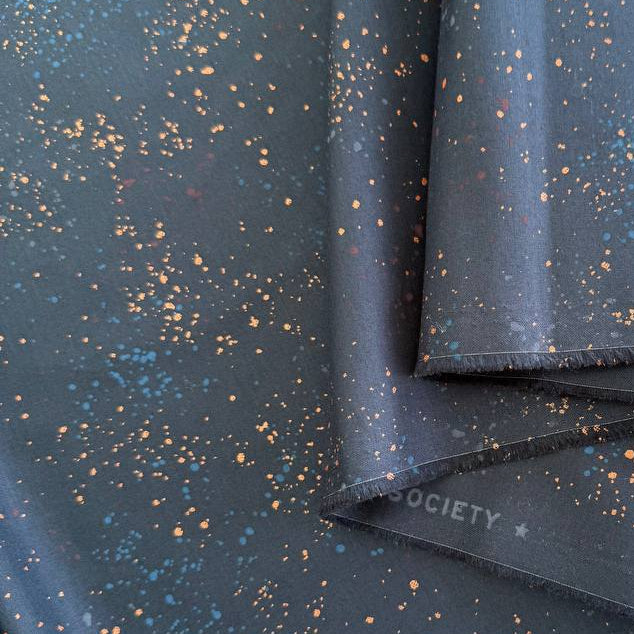 Ruby Star Society Speckled metallic cotton fabric available in navy, pink, and orange colors.