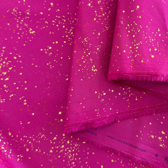 Ruby Star Society Speckled metallic cotton fabric available in navy, pink, and orange colors.