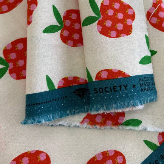 Mystic Fable apple print linen cotton fabric by Ruby Star Society in natural and black colorways.