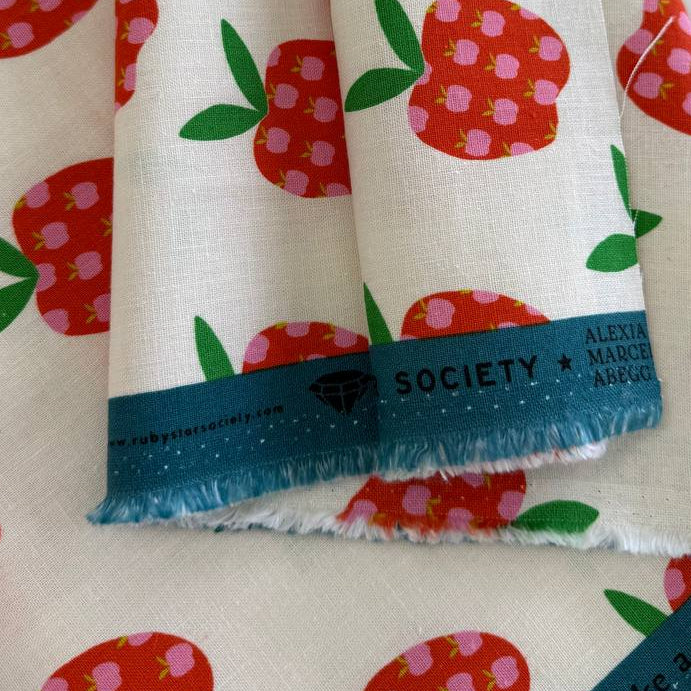 Mystic Fable apple print linen cotton fabric by Ruby Star Society in natural and black colorways.