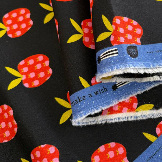 Mystic Fable apple print linen cotton fabric by Ruby Star Society in natural and black colorways.
