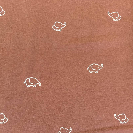Brown cotton jersey knit fabric with small white elephant print.