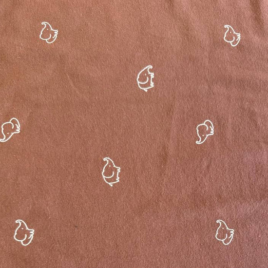 Brown cotton jersey knit fabric with small white elephant print.