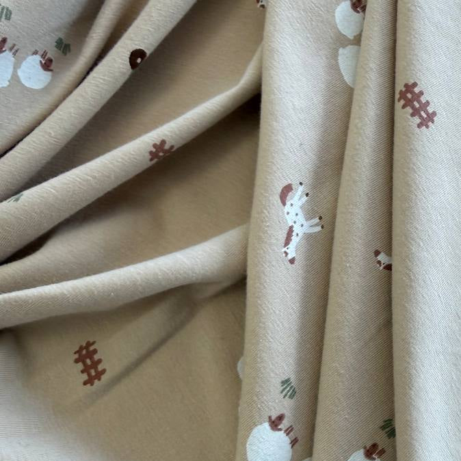 Beige cotton jersey fabric with small farm animals, sheep, horses, tractors, and fence illustrations.