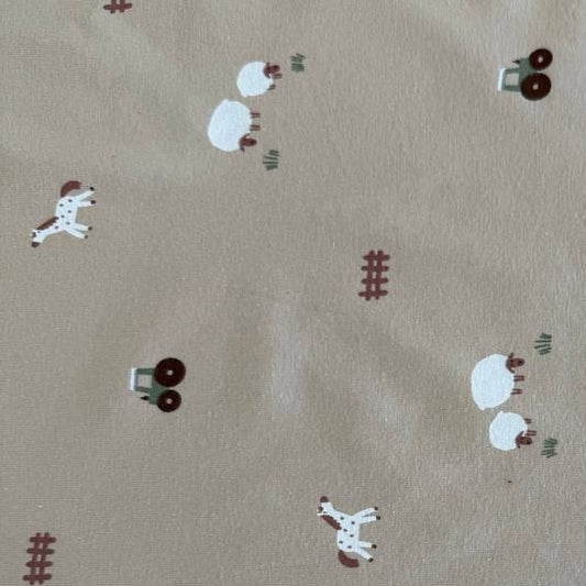 Beige cotton jersey fabric with small farm animals, sheep, horses, tractors, and fence illustrations.