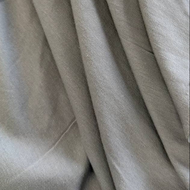 Light grey brushed French terry fabric draped close-up
