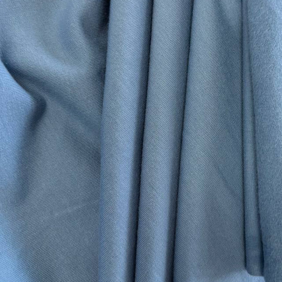 Soft blue brushed French terry fabric draped close-up