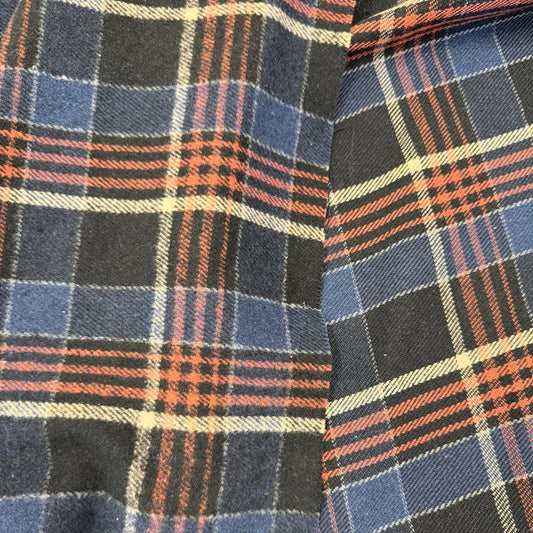 Double-sided yarn-dyed plaid fabric in navy, black, red and cream, made from 85% cotton and 15% polyester.