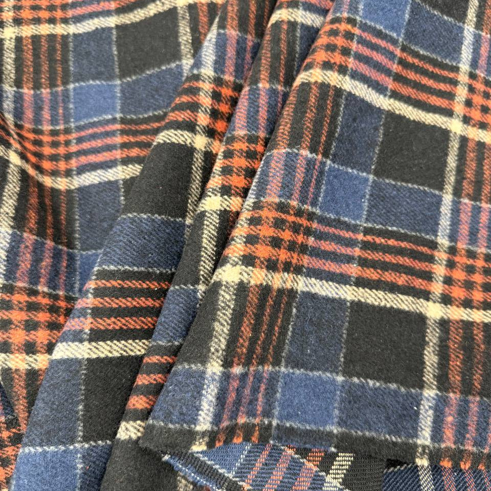 Double-sided yarn-dyed plaid fabric in navy, black, red and cream, made from 85% cotton and 15% polyester.