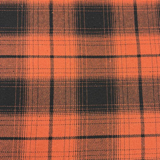 Orange and black yarn-dyed plaid fabric with a classic tartan-inspired pattern.