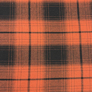 Orange and black yarn-dyed plaid fabric with a classic tartan-inspired pattern.