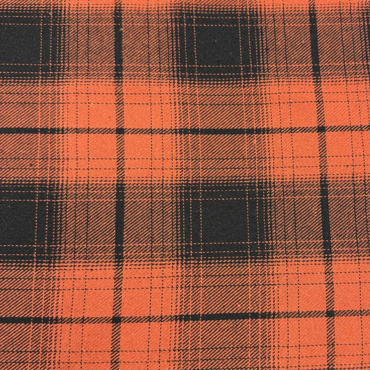 Orange and black yarn-dyed plaid fabric with a classic tartan-inspired pattern.