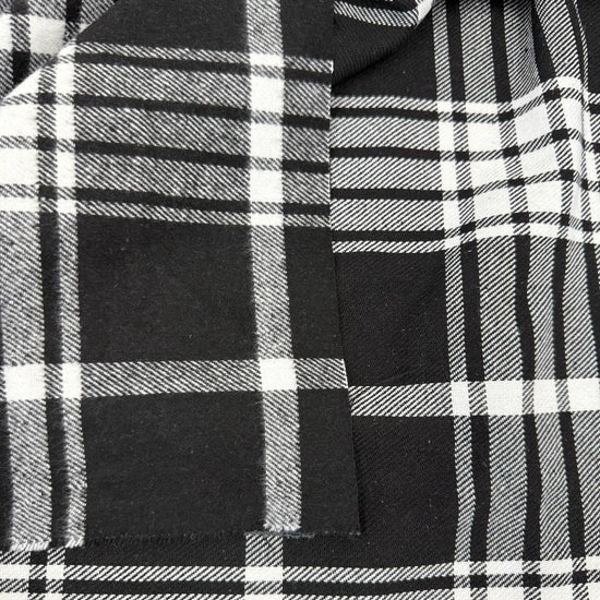 Black and white double-sided yarn-dyed plaid fabric with a classic tartan pattern.