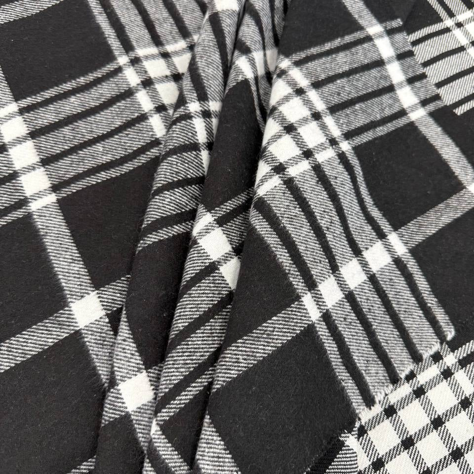Black and white double-sided yarn-dyed plaid fabric with a classic tartan pattern.