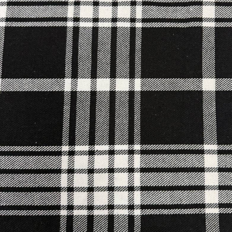 Black and white double-sided yarn-dyed plaid fabric with a classic tartan pattern.