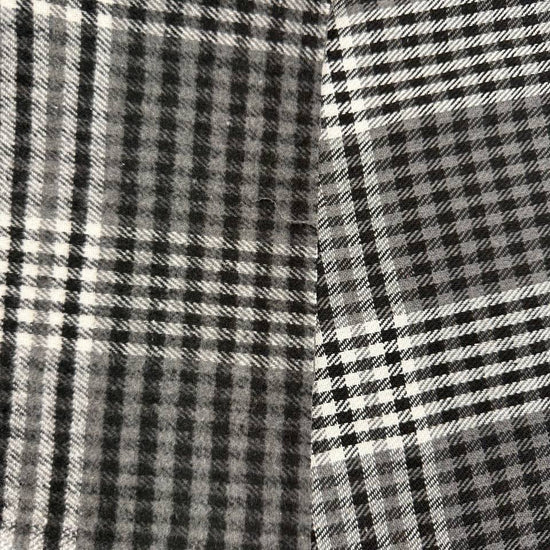 Black, grey and white double-sided yarn-dyed plaid fabric with a classic tartan pattern.