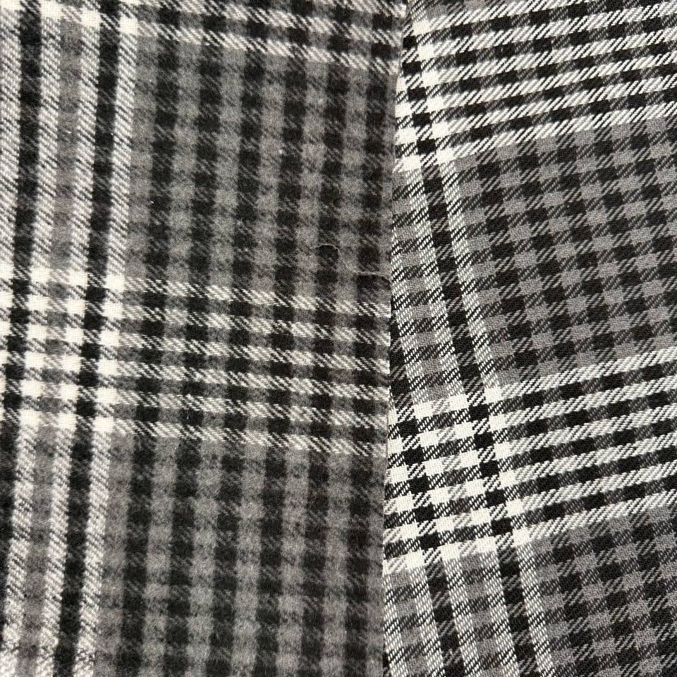 Black, grey and white double-sided yarn-dyed plaid fabric with a classic tartan pattern.
