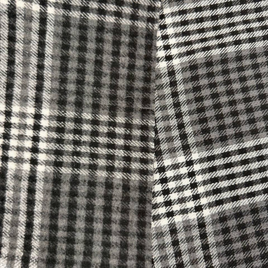 Black, grey and white double-sided yarn-dyed plaid fabric with a classic tartan pattern.