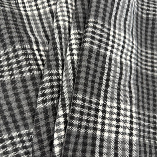 Black, grey and white double-sided yarn-dyed plaid fabric with a classic tartan pattern.