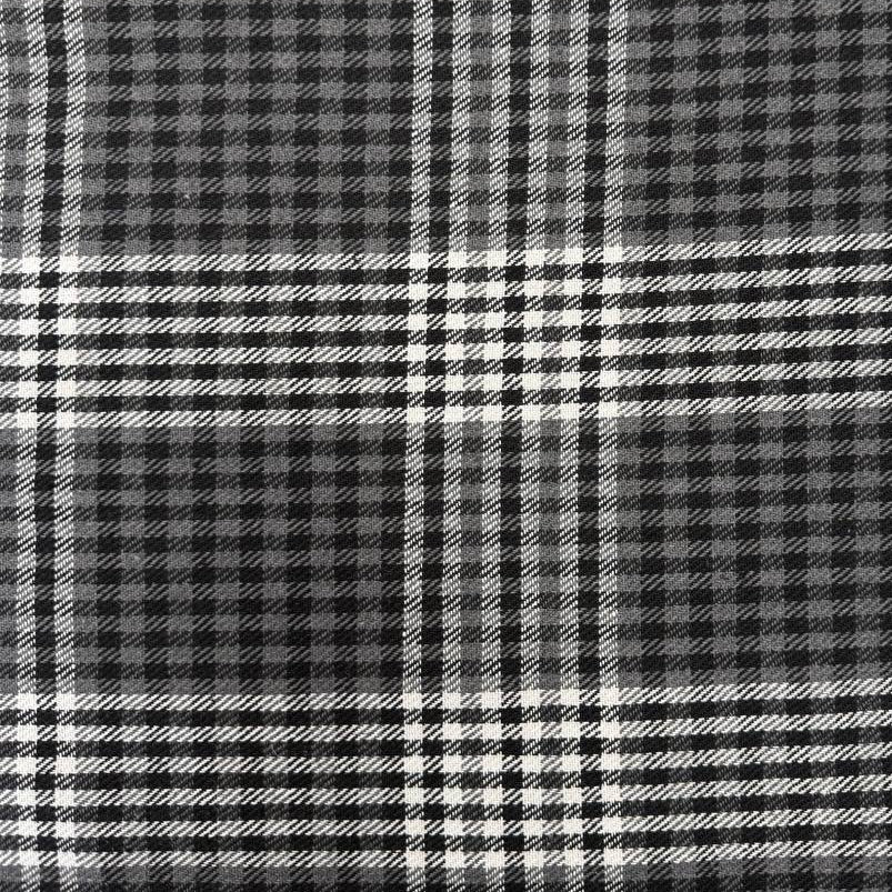 Black, grey and white double-sided yarn-dyed plaid fabric with a classic tartan pattern.