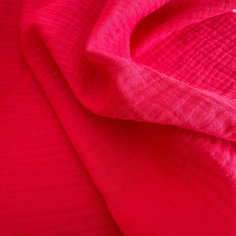 Soft and breathable double gauze fabric in a bright red shade.