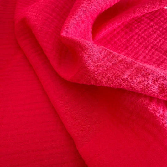 Soft and breathable double gauze fabric in a bright red shade.