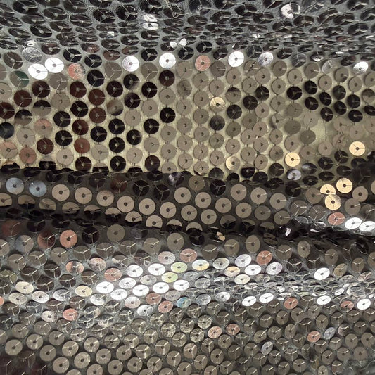 Black sequin fabric with dense round sequins sewn onto a soft mesh base, creating a bold reflective surface and fluid drape.