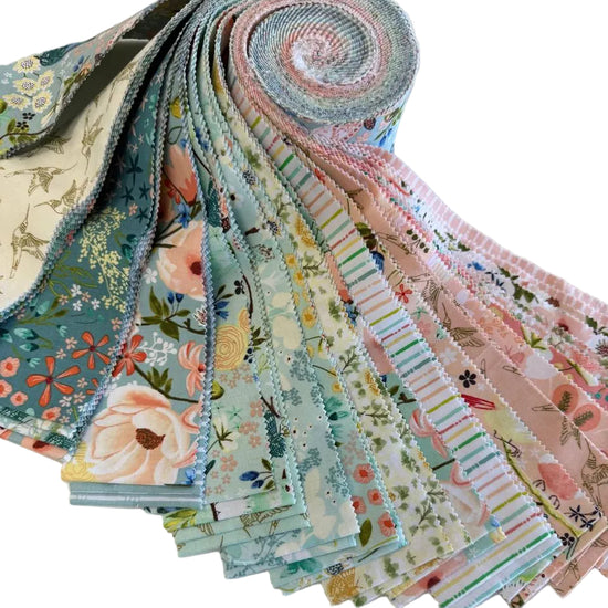 Serenity Blooms 2.5 inch precut fabric strips by Ginger Deverell for Poppie Cotton in soft pastel floral prints and coordinating designs.