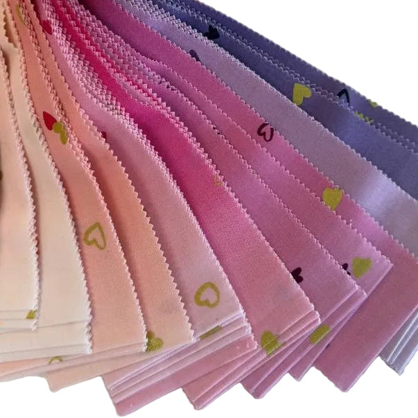 I Heart Ombre Metallic Jelly Roll by Moda Fabrics featuring 40 precut 2.5 inch cotton strips in pink, coral, and lavender ombré shades with metallic heart accents.