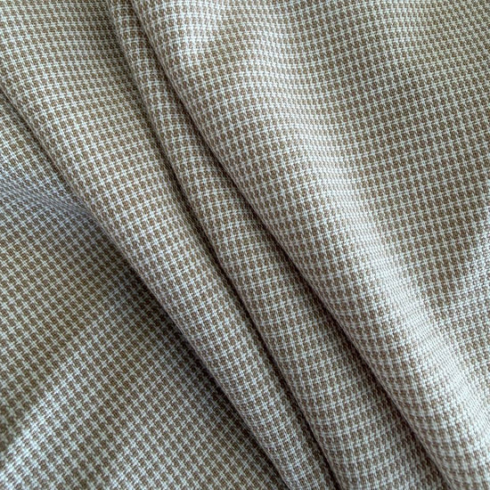 Soft and structured suiting fabric in a refined beige micro-check pattern.
