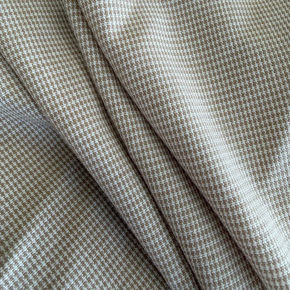 Soft and structured suiting fabric in a refined beige micro-check pattern.