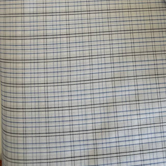 Lightweight shirting fabric in a refined blue micro check pattern.