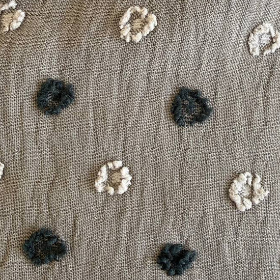 Elegant fancy cotton jacquard fabric in a sophisticated taupe shade featuring a subtle woven dot pattern.