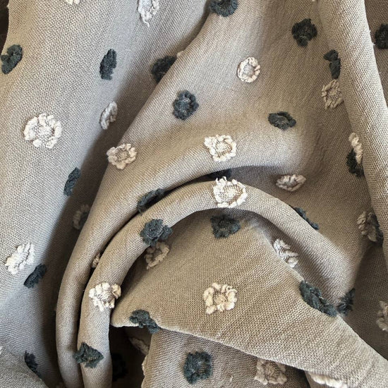 Elegant fancy cotton jacquard fabric in a sophisticated taupe shade featuring a subtle woven dot pattern.