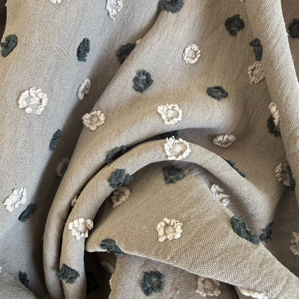 Elegant fancy cotton jacquard fabric in a sophisticated taupe shade featuring a subtle woven dot pattern.