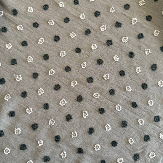 Elegant fancy cotton jacquard fabric in a sophisticated taupe shade featuring a subtle woven dot pattern.