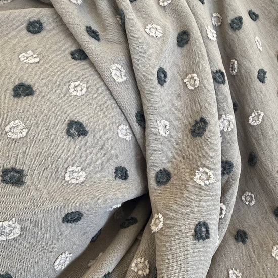 Elegant fancy cotton jacquard fabric in a sophisticated taupe shade featuring a subtle woven dot pattern.