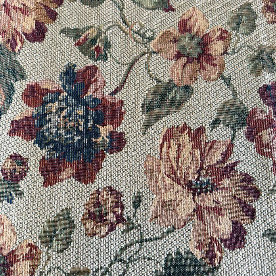 ecorative jacquard upholstery fabric with a rich woven floral pattern and textured surface.