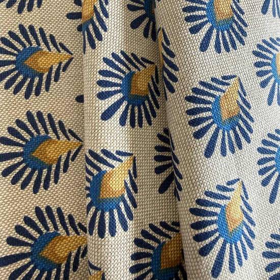 Beautiful 100% cotton home décor fabric with a structured weave and decorative botanical pattern in deep blue and warm mustard tones on a natural background.