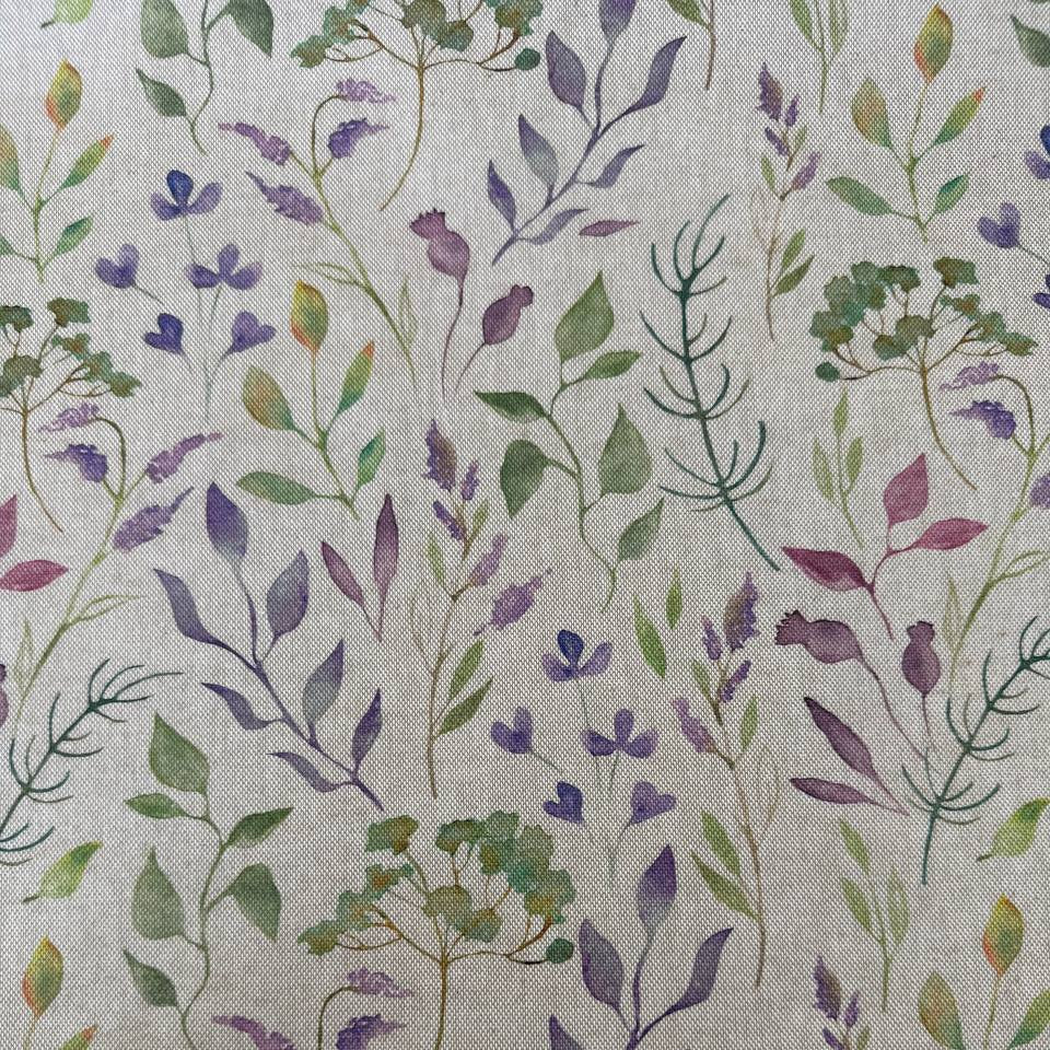 Decorative home décor fabric featuring a soft floral print in purple and green tones on a natural base.