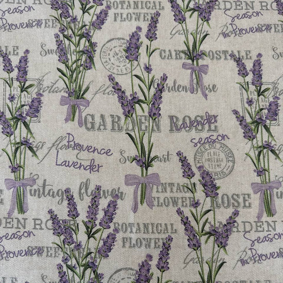 Elegant home décor fabric featuring a delicate lavender botanical print on a natural textured base.