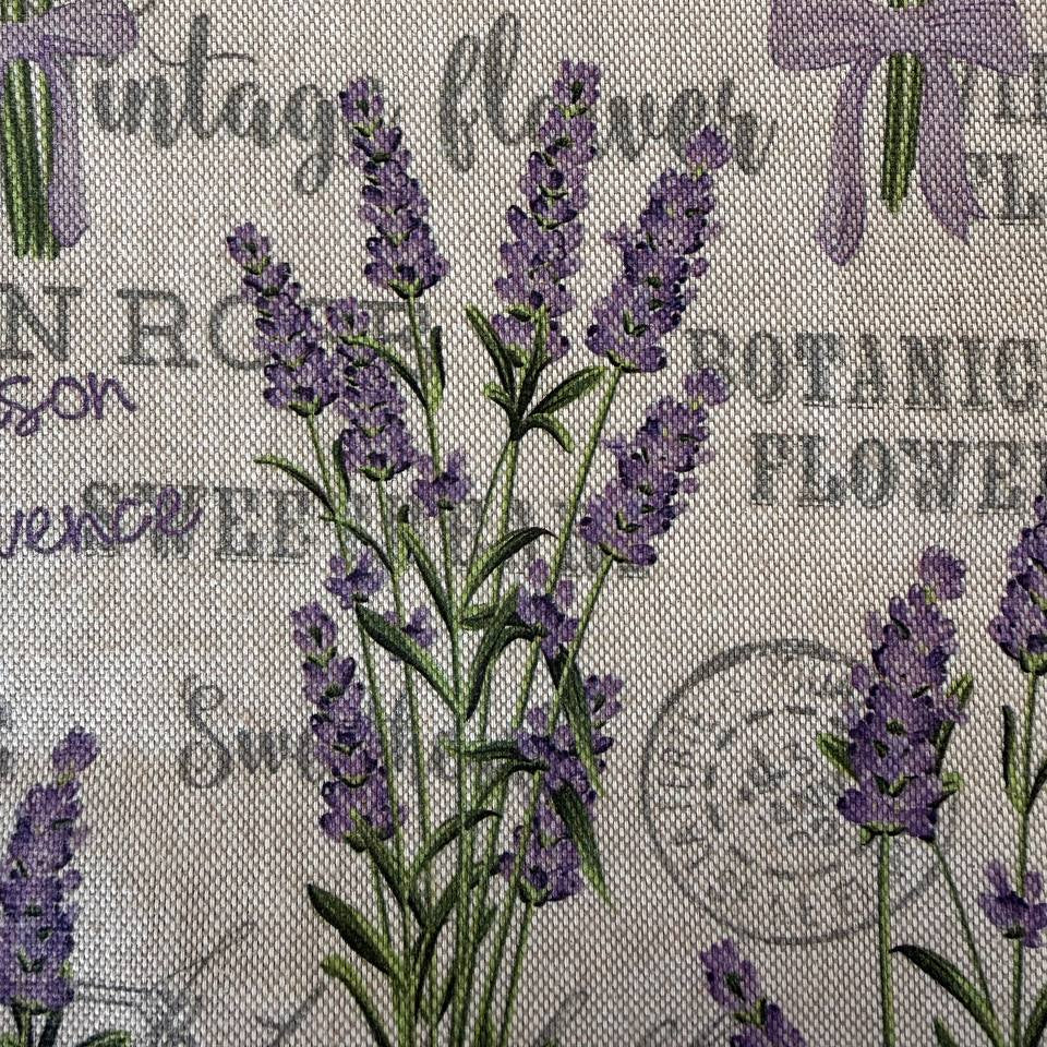 Elegant home décor fabric featuring a delicate lavender botanical print on a natural textured base.