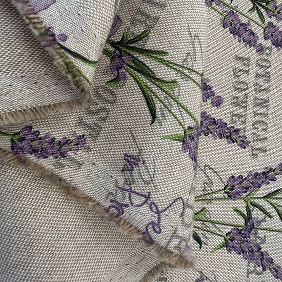 Elegant home décor fabric featuring a delicate lavender botanical print on a natural textured base.