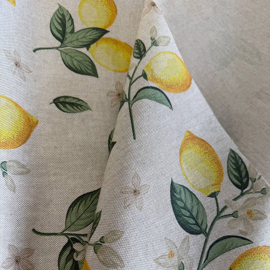 Elegant home décor fabric featuring a fresh botanical lemon print on a soft ivory background. 