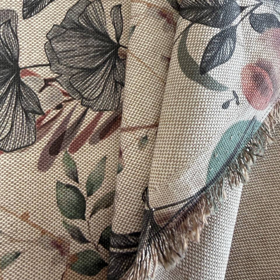 Elegant home décor fabric featuring a beautiful tropical botanical print with leaves, florals, and natural plant elements