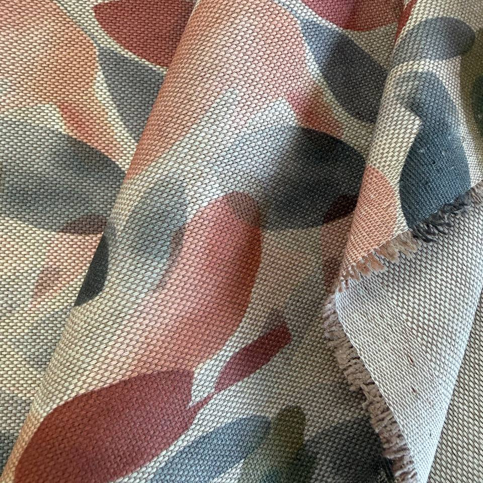 Modern home décor fabric featuring an abstract leaf pattern in soft earthy tones. 