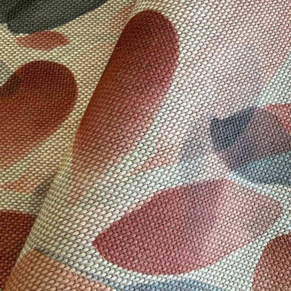 Modern home décor fabric featuring an abstract leaf pattern in soft earthy tones. 