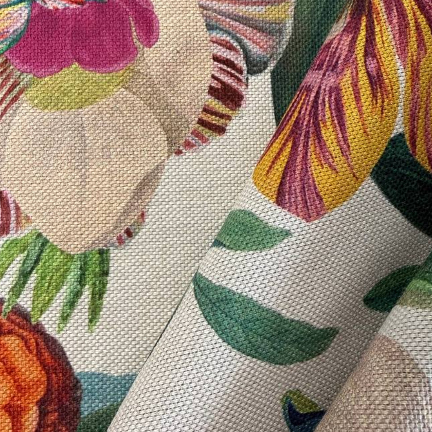 Beautiful botanical home décor fabric featuring an abundant floral garden print with vibrant flowers and lush green foliage on a soft ivory background